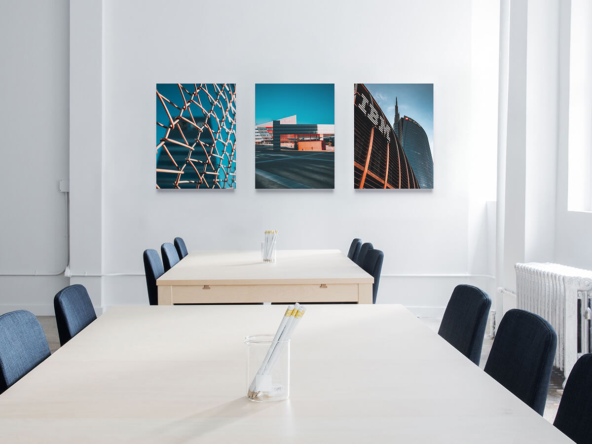 Three canvas prints above two meeting tables