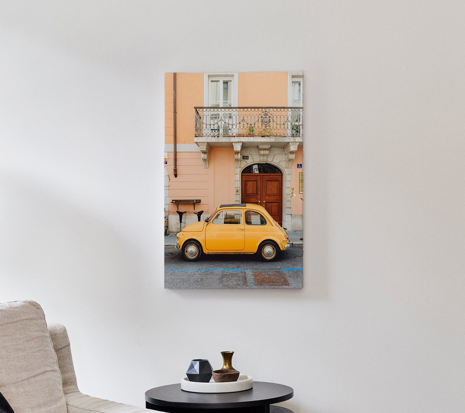 A canvas hanging on the wall above a livingroom couch.